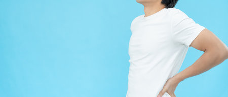 man holding her lower back while and suffer from unbearable pain health and problems, chronic back pain, backache in office syndrome, scoliosis, herniated disc, muscle inflammationの写真素材