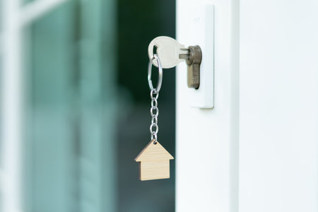 Landlord key for unlocking house is plugged into the door. Second hand house for rent and sale. Owner use hand unlock door mortgage for new home, buy, sell, renovate, investment, owner, estateの写真素材