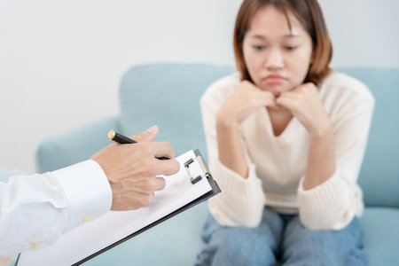 woman with mental health problems is consulting. psychiatrist is recording the patient's condition for treatment. encouragement, love and family problem, bipolar , depression patient, protect suicideの写真素材