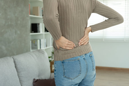 woman holding her lower back while and suffer from unbearable pain health and problems, chronic back...