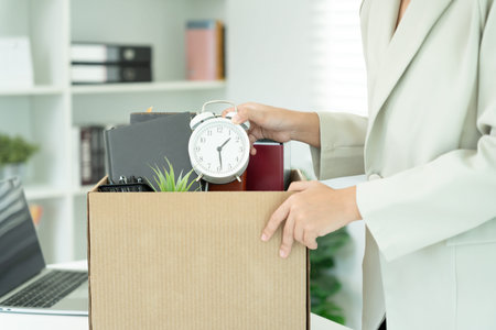 resignation, leave, quit, Stressful businesswomen will resign from the company. Female staff is lifting a brown paper box that holds personal items. , job placement and vacancies, resignation letterの写真素材