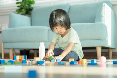 Happy Asian child playing and learning toy blocks. children are very happy and excited at home. child have a great time playing, activities, development, attention deficit hyperactivity disorderの写真素材