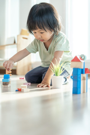 Happy Asian child playing and learning toy blocks. children are very happy and excited at home. child have a great time playing, activities, development, attention deficit hyperactivity disorderの写真素材