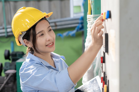 Engineers or factory managers wearing safety helmet inspect the machines in the production line. Utility inspector check machine and test the system to meet the standard. machine, maintenance.の写真素材