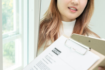 Beautiful woman preparing before job interview, building confidence, job applicants resume to...