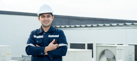 Portrait Asian maintenance engineer works on the roof of factory. contractor inspect compressor...