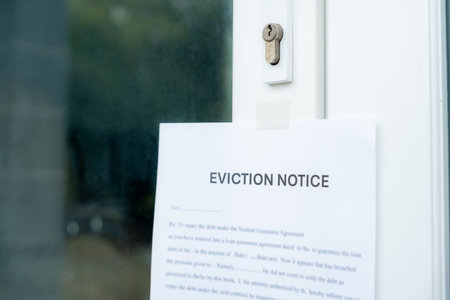 document with the text eviction notice, Civil servant sticks a notice of eviction of the tenants hangs on the door of the house, debt, property, loan, agent, bankruptcy, dispossess, problemの写真素材