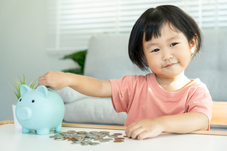 Save money. children putting coin for saving. wealth, Finance, insurance, investment, education, future, plan life, learn, banking, family, health, health and accident insurance.の写真素材
