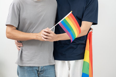 LGBT group. Male bisexualities couple holding hands encourage and show lgbt flag, happily, lover in love, bisexualities, homosexuality, liberty, expression, happy life, life style, freedom, respectの写真素材