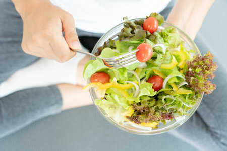 Diet and dieting, enjoy eat. Healthy woman hold salad food and feeling happy. Beauty slim female body achieves weight loss goal for healthy life, crazy about thinness, thin waist, nutritionist.の写真素材