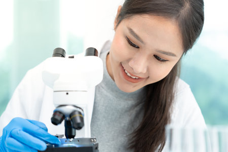 Scientist analyze biochemical samples in advanced scientific laboratory. Medical professional use microscope look microbiological developmental of viral. Biotechnology research in science lab.の写真素材