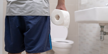 Constipation and diarrhea in bathroom. Hurt man touch belly  stomach ache painful. colon inflammation problem, toxic food, abdominal pain, abdomen, constipated in toilet, stomachache, Hygieneの写真素材