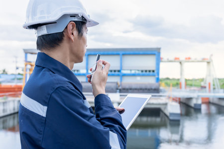maintenance and inspector. Maintenance engineers are using walky talky to inform the results of...