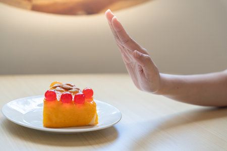 Beauty slim female body confuse desserts. Woman in restaurant achieves weight loss goal for healthy life, crazy about thinness, thin waist, nutritionist. Diet, body shape.の写真素材