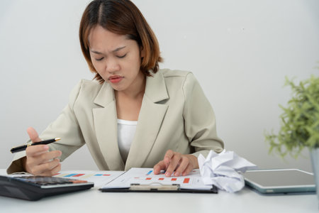 Debt business, Stressed and headache business asian woman analysis financial company problem. no money to pay, shortage, Financial problems, mortgage, loan, bankruptcy, bankrupt, poor, overdueの写真素材