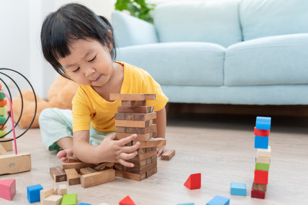 Happy Asian child playing and learning toy blocks. children are very happy and excited at home. child have a great time playing, activities, development, attention deficit hyperactivity disorderの写真素材