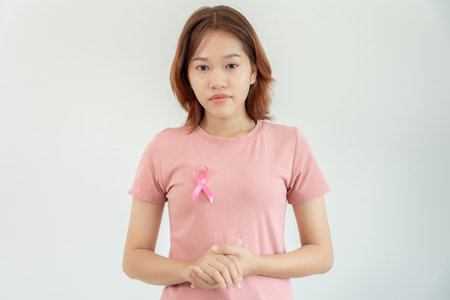 Woman and pink ribbon breast cancer awareness. Female health check consciousness. international Women Day and World Cancer Day. sign cancer, Symbolic, health care, support patients, timely diagnosisの写真素材