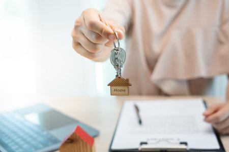 lease, rental and selling home. Real estate agent manager holding key for new owner.  rent house, Sales, loan credit financial, insurance, Seller, dealer, installment,  buy, sell, move inの写真素材