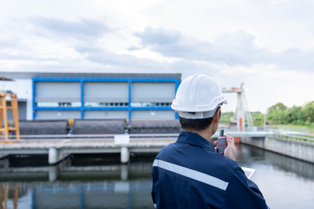 maintenance and inspector. Maintenance engineers are using walky talky to inform the results of inspection of buildings and structures. Irrigation engineers are exploring sluice systemsの写真素材