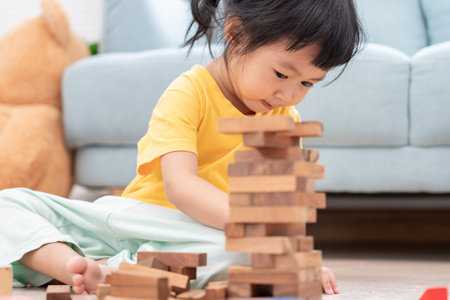 Happy Asian child playing and learning toy blocks. children are very happy and excited at home. child have a great time playing, activities, development, attention deficit hyperactivity disorderの写真素材