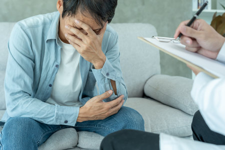 man with mental health problems is consulting. psychiatrist is recording the patient's condition for treatment. encouragement, love and family problem, bipolar , depression patient, protect suicideの写真素材