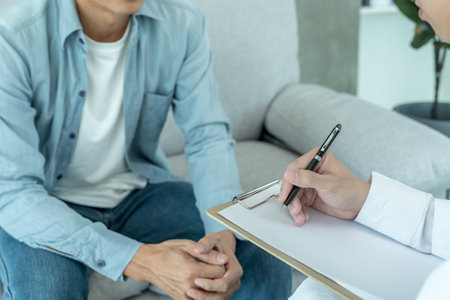 man with mental health problems is consulting. psychiatrist is recording the patient's condition for treatment. encouragement, love and family problem, bipolar , depression patient, protect suicideの写真素材