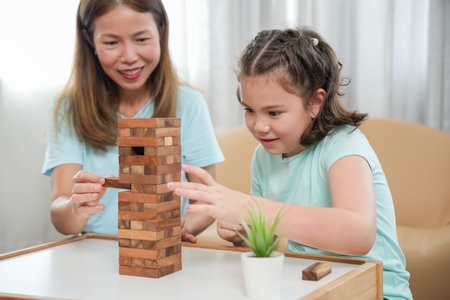 Asia Happy mother playing learning games jan-ga with the little girl. Funny family is happy and...