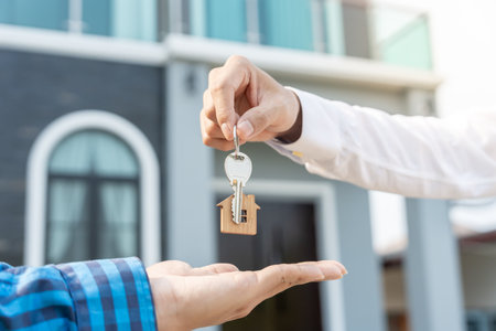 lease, rental and selling home. Real estate agent manager smile holding key for new owner. rent house, Sales, loan credit financial, insurance, Seller, dealer, installment,  buy, sell, move inの写真素材