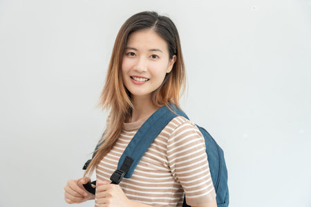 Portrait beautiful Asian woman student. Smile girl happy study. read book in college campus. young female on international Asia University. Education, study, school, learning, exam, continue educationの写真素材