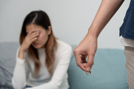 Divorce. Man remove married ring. Couples desperate and disappointed after marriage. Husband wife sad, upset and frustrated after quarrels conflict. distrust, love problems, betrayals, family, loverの写真素材