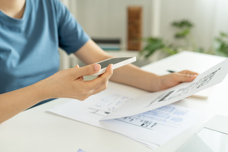 woman use phone to scan barcode or QR codes to pay credit card bill after receiving document invoice online. payment, receive, paying electricity, digital payments, technology, scanning, financial transactionsの写真素材