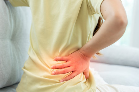 woman holding her lower back while and suffer from unbearable pain health and problems, chronic back...