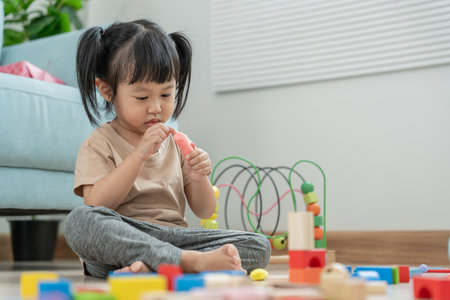Happy Asia children play and learn toy blocks.family is happy and excited in the house. daughter having fun spending time, Activity, development, IQ, EQ, meditation, brain, muscles, essential skills.の写真素材