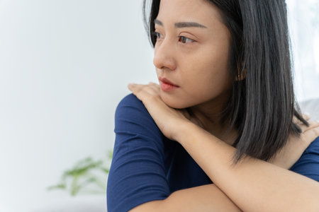 Unhappy asian woman girl disappointed, sad about problem in home alone, feel lonely, Stressed, suffering from bad relationship, break up, divorce, female confused, depression mental health, lonelinessの写真素材