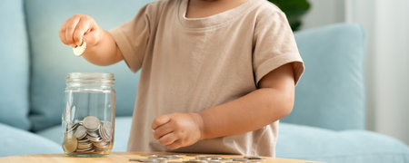 Save money. children putting coin for saving. wealth, Finance, insurance, investment, education, future, plan life, learn, banking, family, health, health and accident insurance.の写真素材