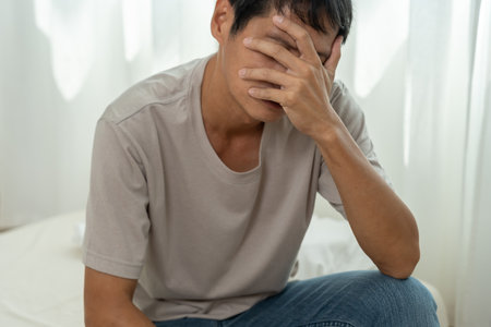 Depression and mental illness. Asian man disappoint, sad after receive bad news. Stressed boy confused with unhappy problem, arguing with girlfriend, cry and worry about unexpected work, down economy.の写真素材