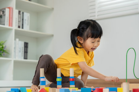 Happy Asian child playing and learning toy blocks. children are very happy and excited at home. child have a great time playing, activities, developmentの写真素材