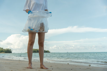Save ocean. Volunteer pick up trash garbage at the beach and plastic bottles are difficult decompose prevent harm aquatic life. Earth, Environment, Greening planetの写真素材