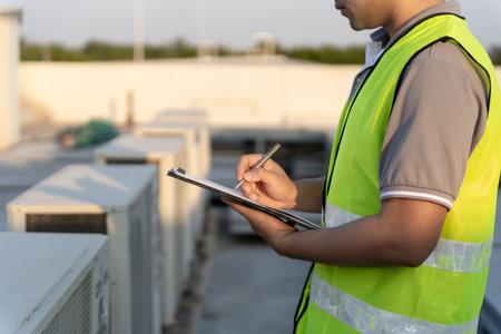Asian maintenance engineer works on the roof of factory. contractor inspect compressor system and plans installation of air condition systems in construction. Checklist, inspectorの写真素材