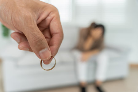 Divorce. Man remove married ring. Couples desperate and disappointed after marriage. Husband wife sad, upset and frustrated after quarrels conflict. distrust, love problemsの写真素材