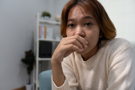 Unhappy asian woman girl disappointed, sad about problem in home alone, feel lonely, Stressed, suffering from bad relationship, break up, divorce, female confusedの写真素材
