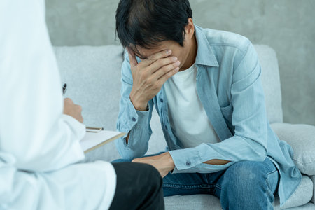 man with mental health problems is consulting. psychiatrist is recording the patient's condition for treatment. encouragement, love and family problem, bipolar , depression patientの写真素材