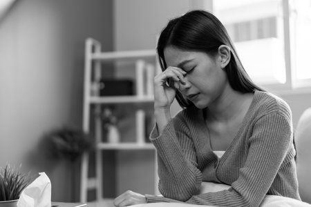 Asian woman disappointed, sad after receiving bad news. Stressed girl confused with unhappy problems, arguing with boyfriend, cry and worry about unexpected pregnancyの写真素材