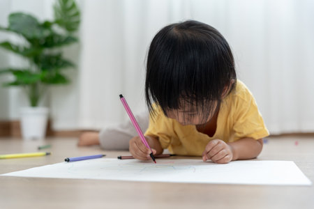 Happy Asian children learning and enjoying paint. Family is happy and excited in the house. Mother and daughter having fun spending time together. Holiday, Activityの写真素材