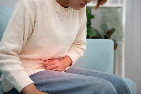 stomach ache. Asian women have abdominal pain, indigestion, gastritis, menstrual cramps, flatulence, diarrhea, distention, colon cancer, belly inflammation problemの写真素材
