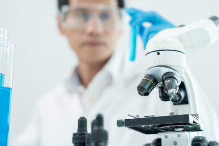 Scientist analyze biochemical sample in advanced scientific laboratory. Medical professional check chemical mix microbiological developmental of viral.の写真素材