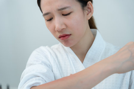 skin problem and beauty. Young woman scratch body has itchy skin from skin allergic, steroid allergy, sensitive skin, red from sunburn, chemical allergy, rash, insect bitesの写真素材