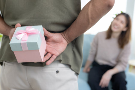 Happy husband seek and hide gift box for surprise wife. cute girl excited  gift box. birthday, Celebration, xmas, New year Festival, thank, Celebrate, Valentine's Day, Anniversaryの写真素材