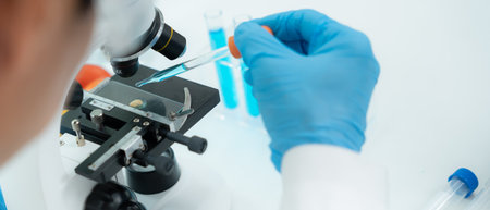 Scientist analyze biochemical samples in advanced scientific laboratory. Medical professional use microscope look microbiological developmental of viral.の写真素材
