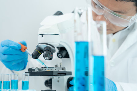 Scientist analyze biochemical samples in advanced scientific laboratory. Medical professional use microscope look microbiological developmental of viral. Biotechnology research in science lab.の写真素材